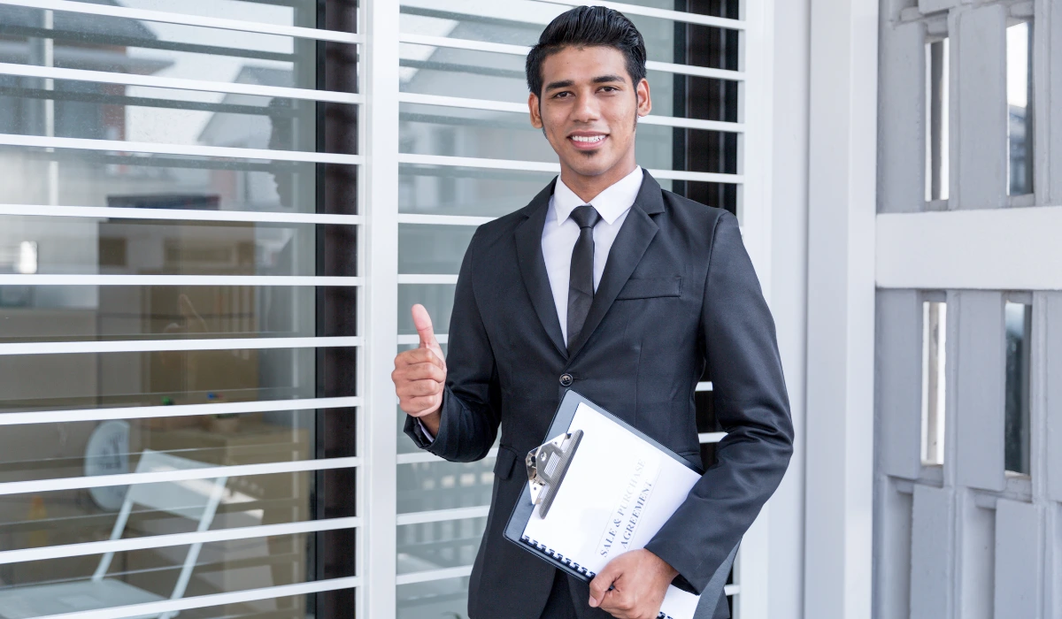Listing agent standing with a file in hand